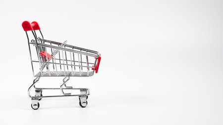 One empty grocery shopping cart isolated over white backgroundの写真素材