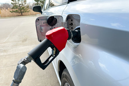 Refilling the car tank with gasoline fuel at the petrol stationの写真素材