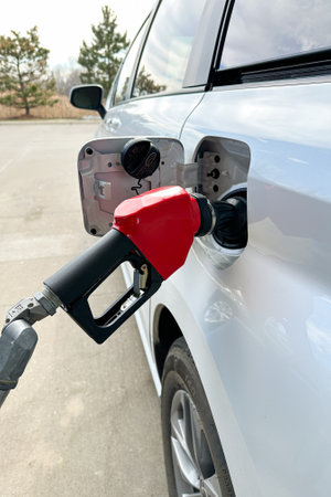 Refilling the car tank with gasoline fuel at the petrol stationの写真素材
