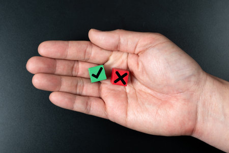 Hand hold wooden blocks with a green check mark and red cross x, choice and decision making concept,...