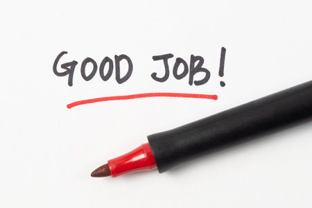 Hand writing good job word or text with red marker pen isolated on white backgroundの写真素材