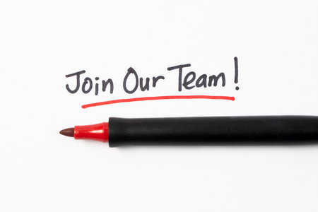 Hand writing Join Our Team with black marker and underline with red marker isolated on white...