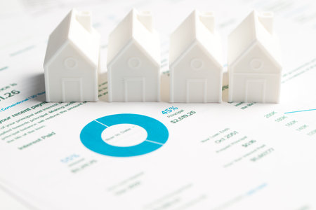 Mortgage loan statement with a white model house. The statement showing principal and interest ratio, represents concepts of homeownership, mortgage payments, and financial planning.の写真素材