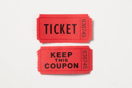 Red vintage raffle ticket and its coupon isolated on white backgroundの写真素材