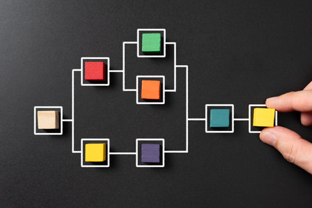 Business process and workflow with flowchart on blackboard, and multicolor wooden cubes fill in some of the squares. Management and organization concept.の写真素材