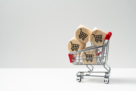 Wooden cubes block with trolley icons in shopping cart, concept of online shopping, sales, promotion, discount or bargainの写真素材