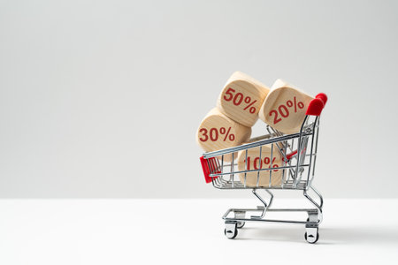 Wooden cubes block with discount percentage icons in shopping cart, concept of online shopping, sales, promotion, discount or bargainの写真素材