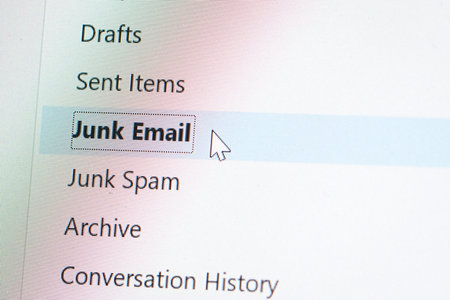 Close up computer or laptop monitor screen focus on spam or junk email folder, mouse clicker hover on spam button.の写真素材