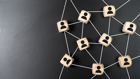 Connecting people or social media networking concept using wood square blocks isolated on black backgroundの写真素材