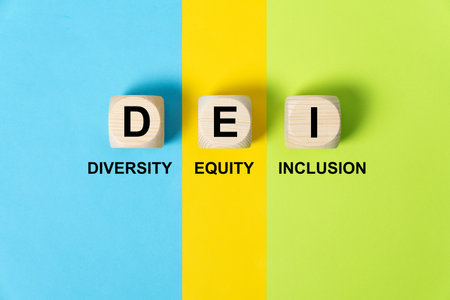 DEI words on wooden cubes on colorful background, which means diversity, equity and inclusion.の写真素材