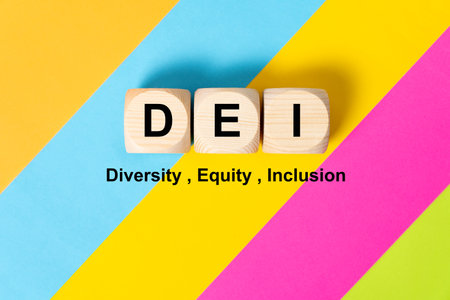 DEI words on wooden cubes on colorful background, which means diversity, equity and inclusion.の写真素材