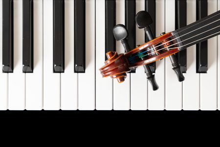 Violin on top of piano keyboard background with copy space for music concept or orchestra concert...