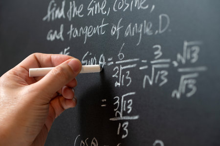 Mathematical operations and trigonometry mathematic formula written with chalk on the blackboardの写真素材