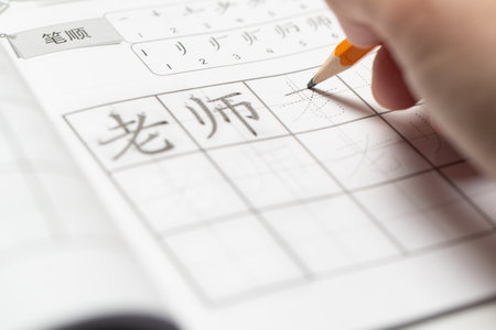 Learning Mandarin concept, learning how to write simplified Chinese word characters, pencil over Tianzi Ge grid paperの写真素材