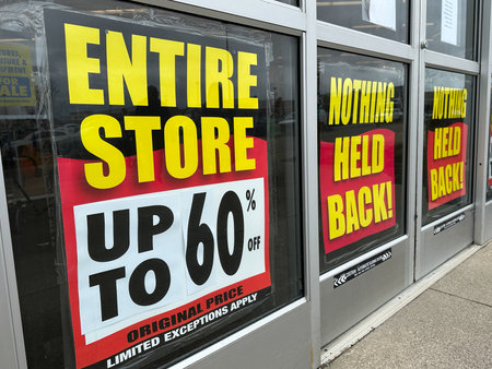 Retail store is going out of business with a large banner displaying store closing saleの写真素材