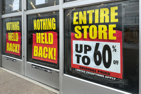 Retail store is going out of business with a large banner displaying store closing saleの写真素材