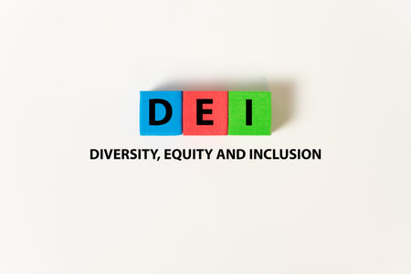 DEI words on blue, red and green cubes on white background, which means diversity, equity and...