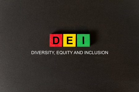 DEI words on red, yellow and green cubes on black background, which means diversity, equity and inclusion.の写真素材