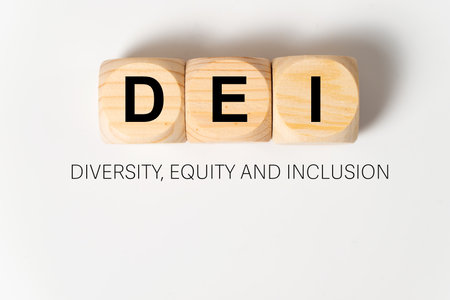 DEI letters written on three wooden cubes on white background, which means diversity, equity and inclusion.の写真素材