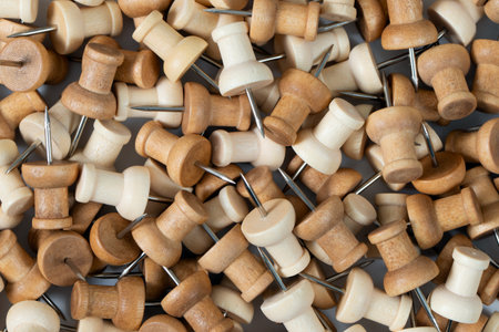 A full-frame image completely covered with natural wooden push pins, filling the entire scene with warm wood textures and metal tips.の写真素材