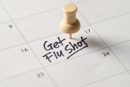 A close-up of a calendar with a handwritten note saying Get Flu Shot, serving as a reminder for an important health appointment. A symbol of influenza prevention and personal healthcare planningの写真素材