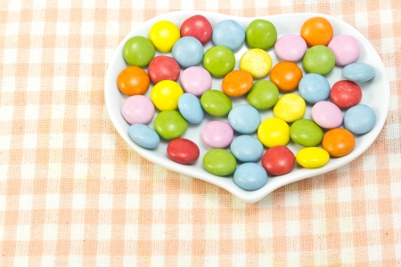 This is a picture of colorful chocolate placed on the table cloth の写真素材
