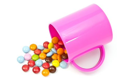 This is a picture of colorful chocolate and mug placed on the table.の写真素材