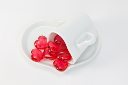This is a picture of a red hearts and heart shaped cup on the table.の写真素材