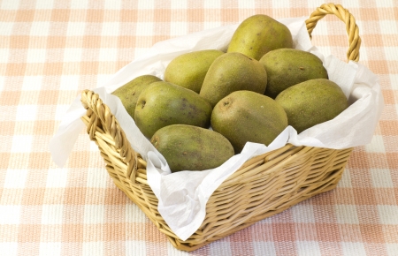 This is a photograph of kiwi fruits served in a basket.