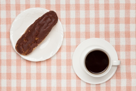 eclair and coffee on table