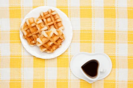 This is a photo of a coffee and waffles.の写真素材