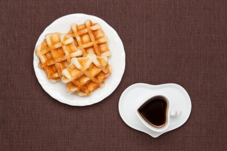 This is a photo of a coffee and waffles.の写真素材