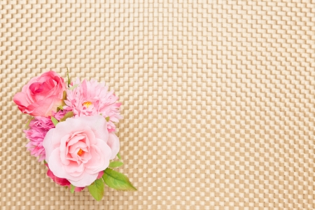 This is a photograph of artificial rose on the table cloth.の写真素材
