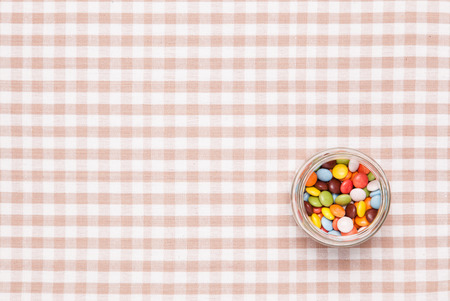 These are colorful chocolate was placed in a glass bottle.の写真素材