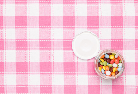 These are colorful chocolate was placed in a glass bottle.の写真素材