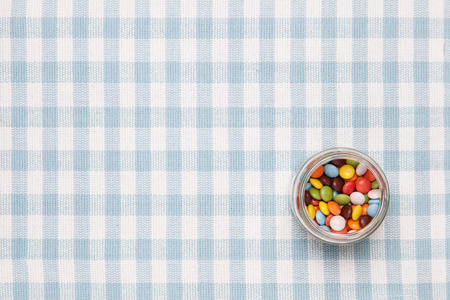 colorful chocolate placed in a glass bottle.