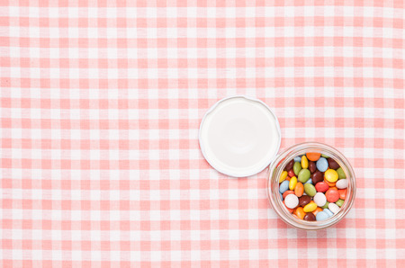 colorful chocolate placed in a glass bottle.の写真素材
