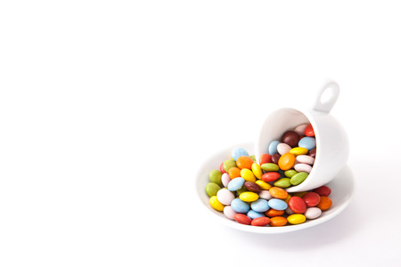 colorful chocolate overflowing from the cup.の写真素材