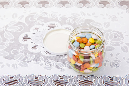 These are colorful chocolate was placed in a glass bottle.の写真素材