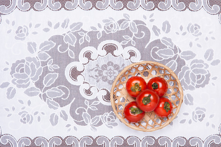 These are the tomatoes on the table and put it in a basket. の写真素材