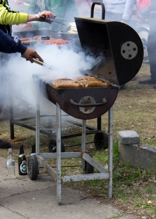 The barbecue smokes and the sausages are readyの写真素材