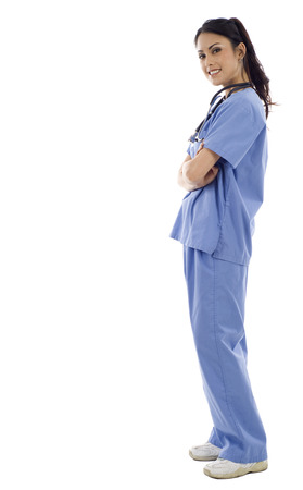 Full length of an Asian female doctor standing against isolated white backgroundの写真素材