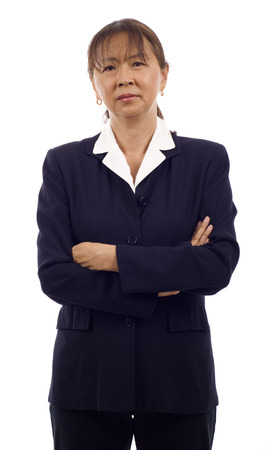 Portrait of a Angry senior Asian business woman with arms folded isolated over white backgroundの写真素材