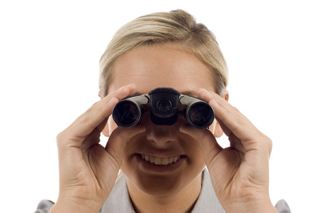 Business search / vision -  Confident business woman with  high tech binoculars isolated over a white backgroundの写真素材