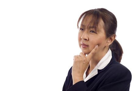 Asian American senior businesswoman thinking against white backgroundの写真素材