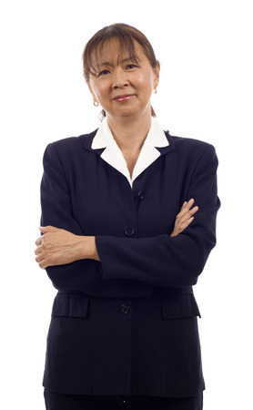 Portrait of a confident senior Asian business woman with arms folded isolated over white backgroundの写真素材
