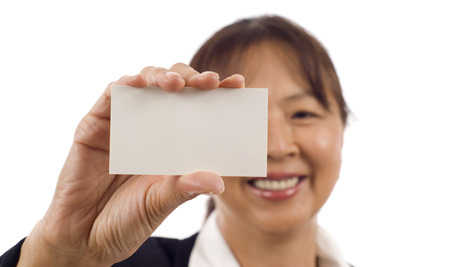 Mature Asian American businesswoman showing business card isolated over white backgroundの写真素材