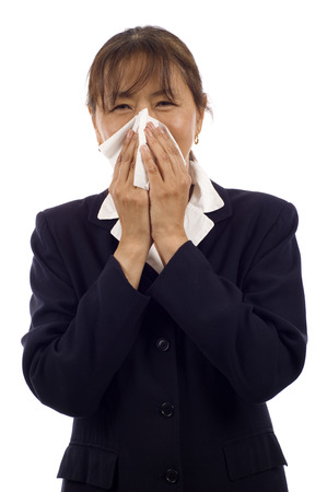 Elderly Asian woman with allergy or cold, isolated over white backgroundの写真素材
