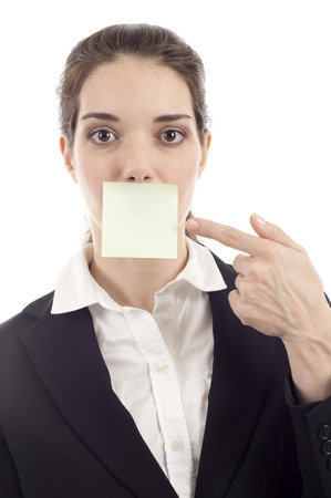 Beautiful woman pointing at the post it note on her mouth isolated over white background
Concept: What Can I Say? Write your message.の写真素材