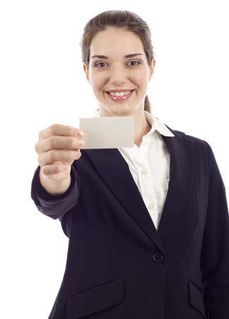 Businesswoman in black suit showing and handing a blank business card isolated over white backgroundの写真素材